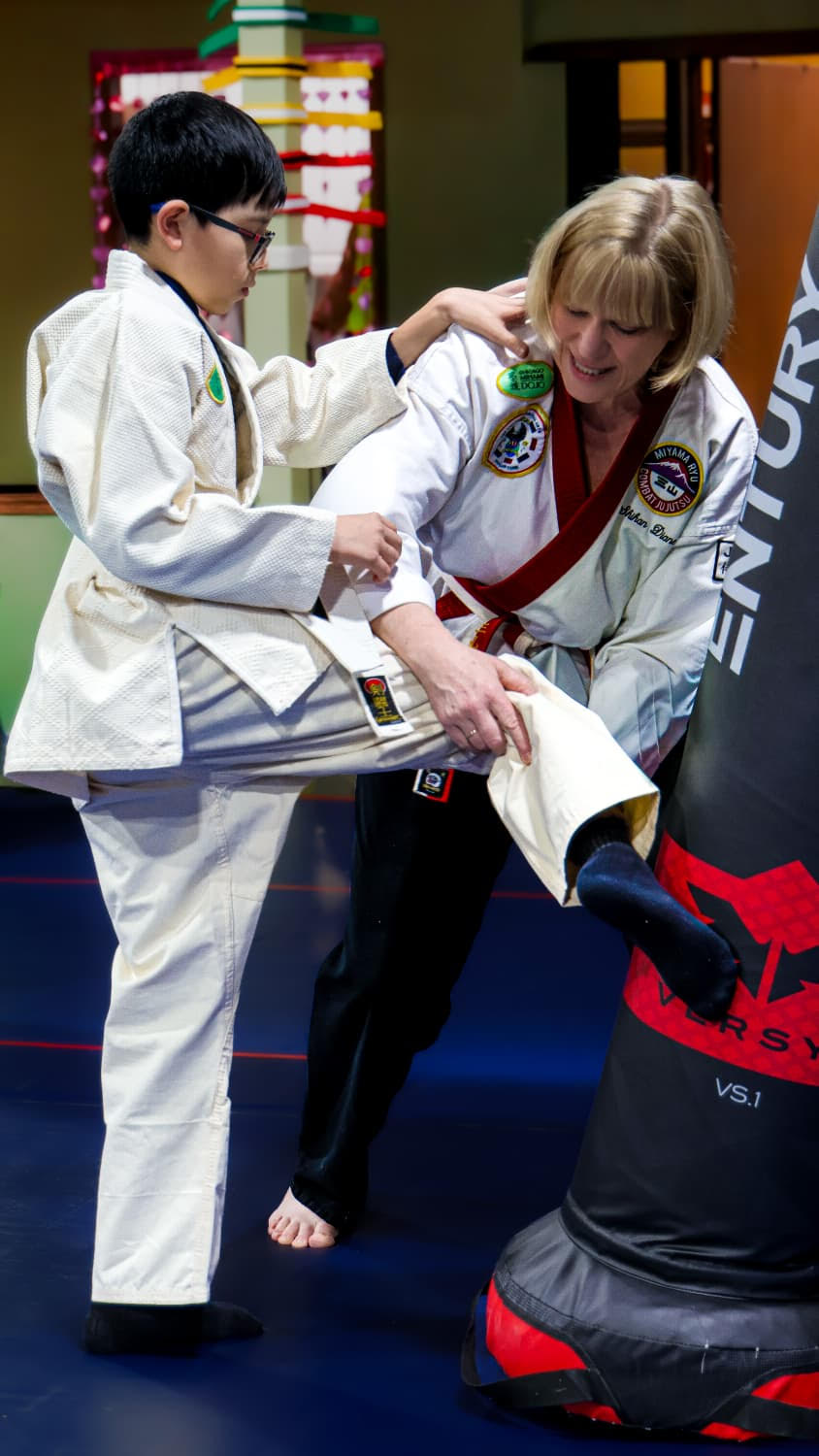 Shihan Diane teaching a young student kick techniques
